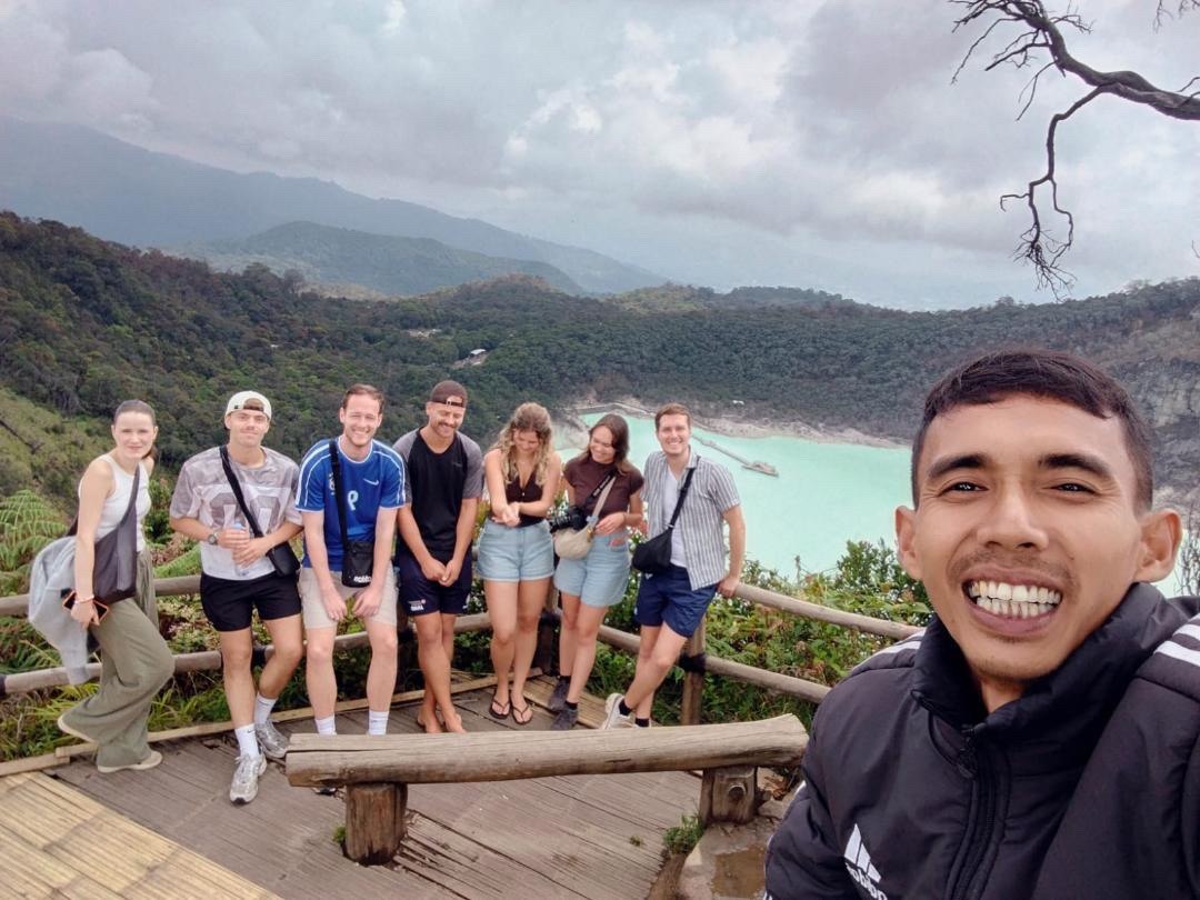 Deni with happy travelers in West Java