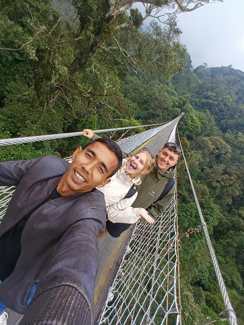Travelers at the historic railway bridge over a valley